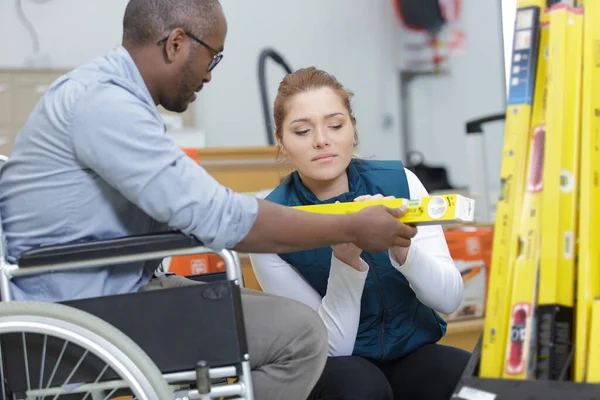 disabled worker in wheelchair in a carpenter workshop