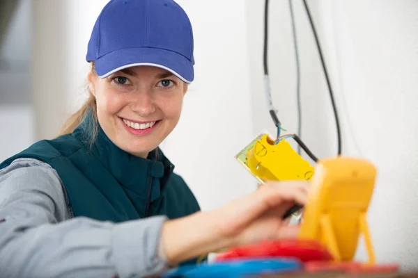Happy Woman Electrician Using Digital Meter — Stock Photo, Image