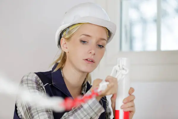 female builder indoors at the working area