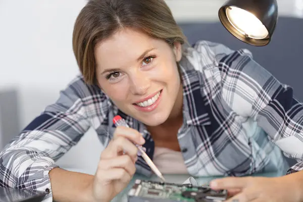 young woman screwing a pc component