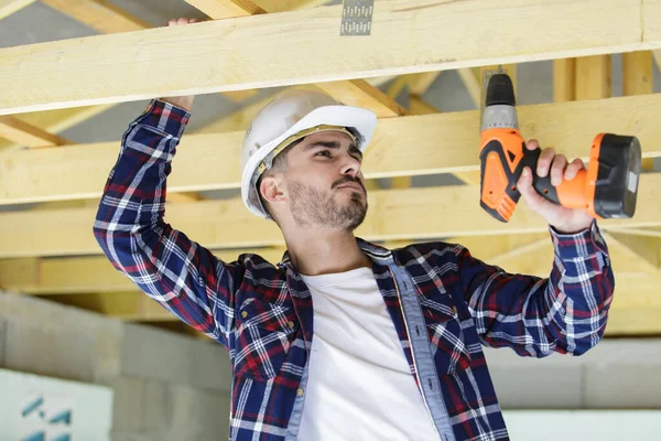 Man Drilling Wooden Frame House — Stock Photo, Image