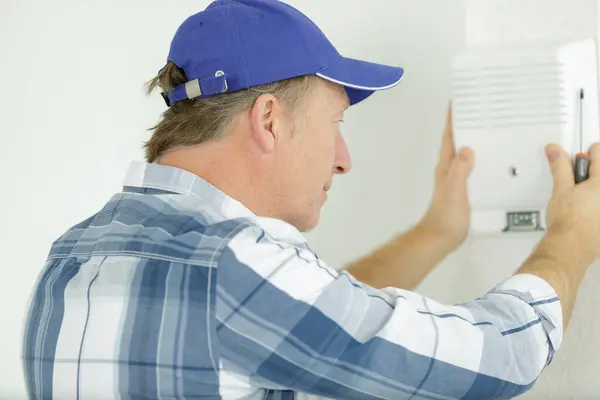Male Electrician Installing Security System Door Sensor Wall Stock Image