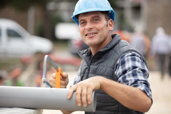 Builder Sawing Pipe Construction Site — Stock Photo, Image