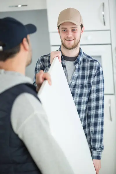 Young Male Movers Unloading Box — Stock Photo, Image