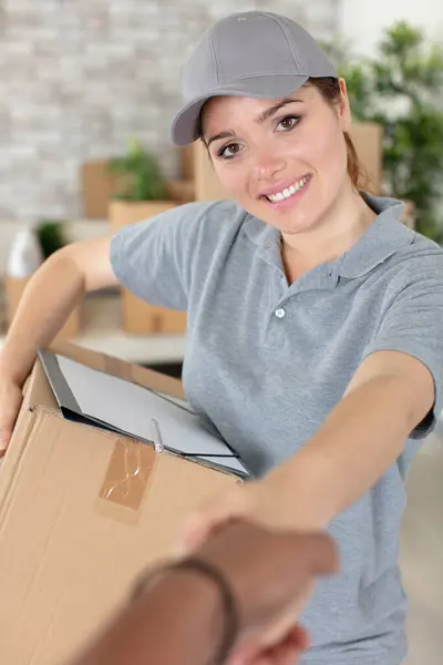 female delivery worker shaking hands with customer