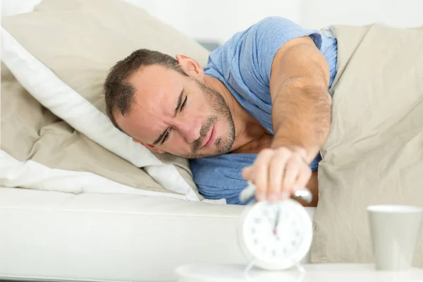 Young Man Turning Alarm Clock Bed — Stock Photo, Image