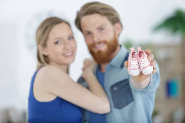 Happy Couple Expecting Baby Holding Baby Shoes — Stock Photo, Image