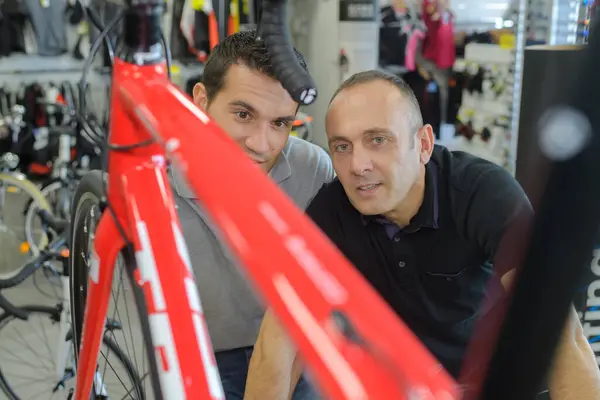 bike mechanic preparing racing bicycles in workshop