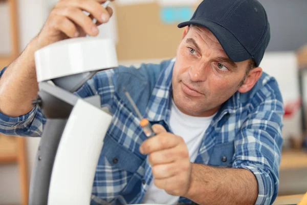 male technician repairing a coffee machine