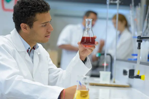 Young Male Chemist Checking Blood Test — Stock Photo, Image