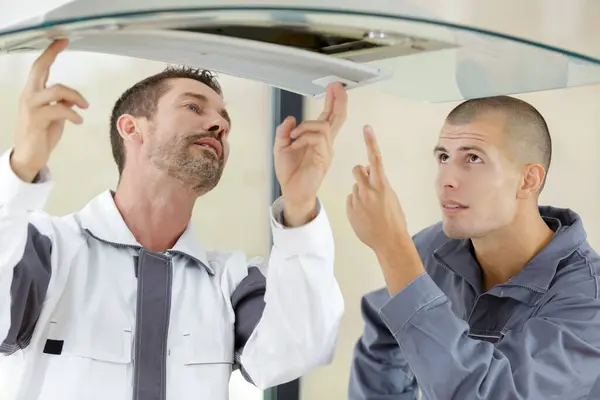 Electricians Repairing Kitchen Extractor Filter — Stock Photo, Image