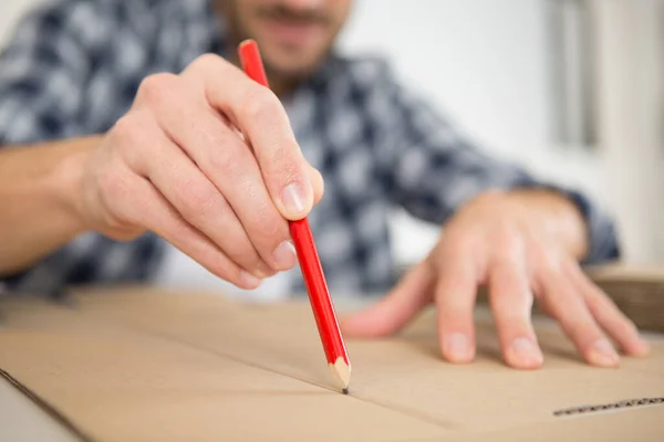 man drawing over a box