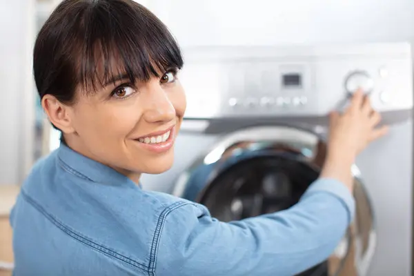 Woman Turning Washing Machine — Stock Photo, Image