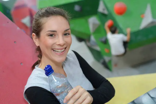 portrait of climber in activity center holding bottle of water