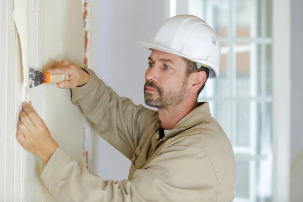 Professional Male Builder Stripping Wallpaper — Stock Photo, Image