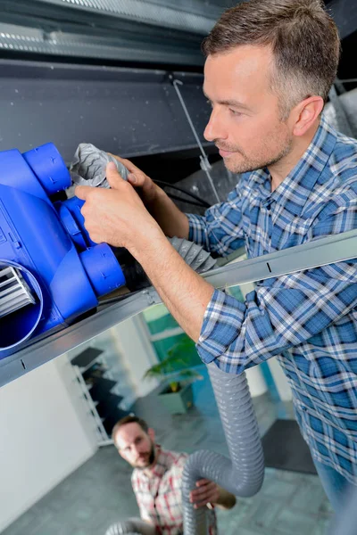 Man Connecting Hose Ventilation Unit — Stock Photo, Image