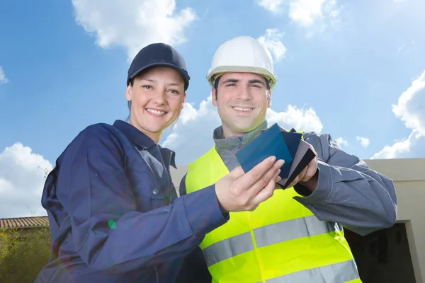 Smiling Builders Hardhats Swatches Outdoors — Stock Photo, Image