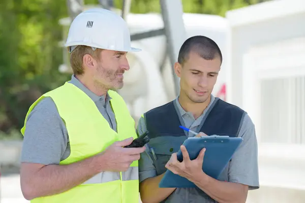 Two Male Builders Working Clipboard Outdoors — Stock Photo, Image