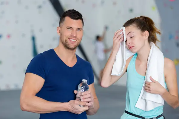 sweat girl wiping her sweat after wall climbing