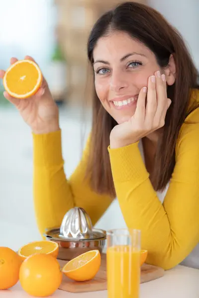 Cheerful Pretty Woman Showing Half Orange — Stock Photo, Image