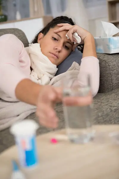 Poorly Woman Sofa Reaches Glass Water — Stock Photo, Image