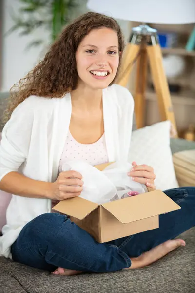 Woman Sitting Couch Living Room Opening Cardboard Box — Stock Photo, Image
