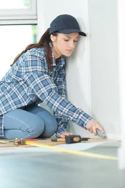young woman working on wood floor