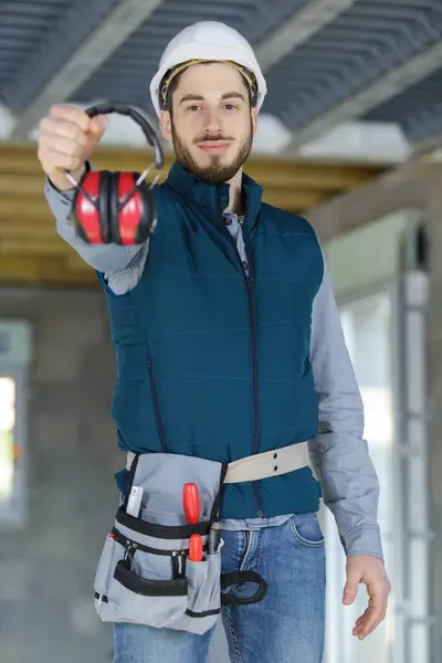 attractive and confident constructor with ear protection gear
