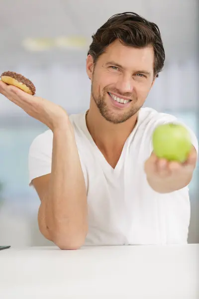 Man Holding Doughnut Apple Recommending Latter — Stock Photo, Image