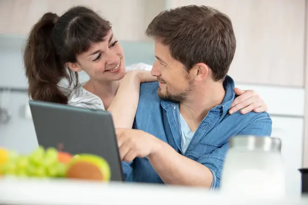 happy young couple with digital tablet