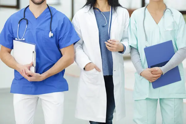 portrait of medical team standing in hospital corridor