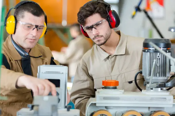 Workers Earmuffs Goggles Fiddling Machine — Stock Photo, Image
