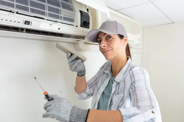 Una Mujer Joven Limpiando Sistema Aire Acondicionado Casa —  Fotos de Stock