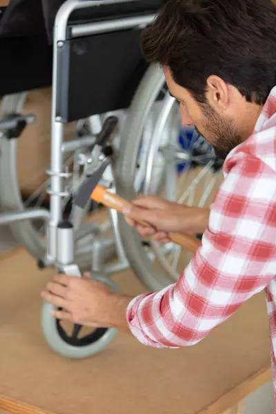 Man Repairing Wheelchair Workshop — Stok fotoğraf