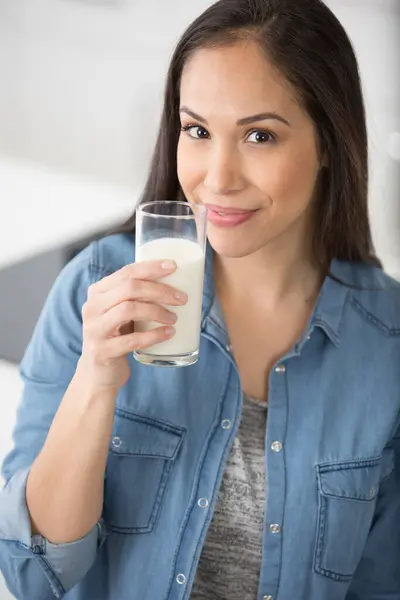 happy young woman drinking milk