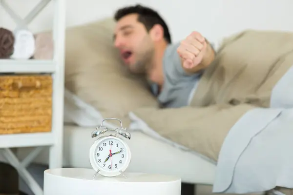 man having trouble waking up in morning