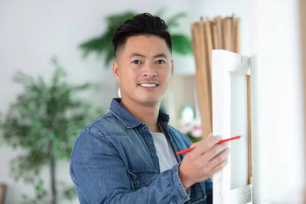 handsome young man installing bay window construction site