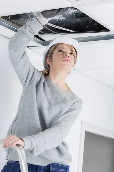 maintenance worker inspecting a ceiling leak