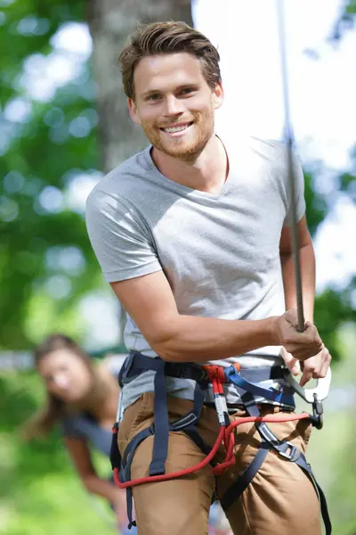 man spends his leisure time in a ropes course