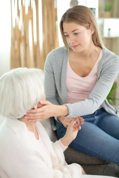 Young Daughter Taking Care Senior Mother Stock Image