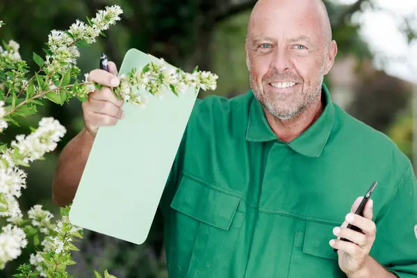 Male Florist Writing Clipboard His Flower Shop — Stock Photo, Image
