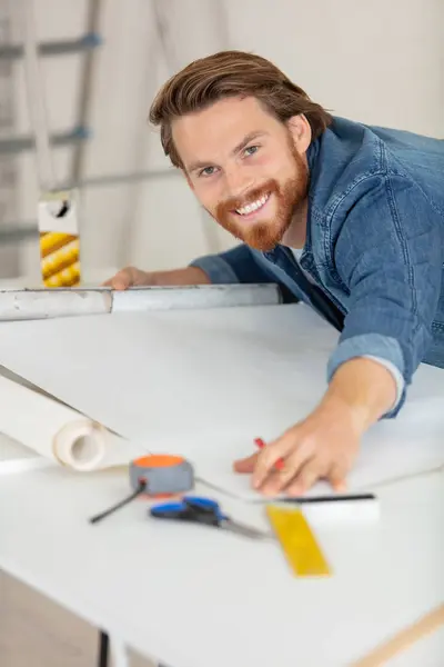 vertical view of focused carpenter at work