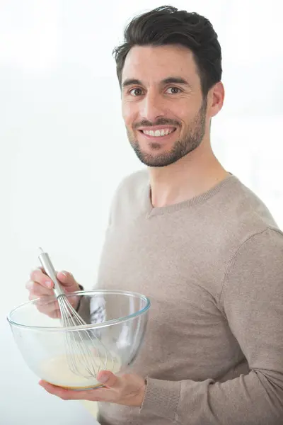 stock image a man making breakfast at home