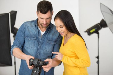 the team of two photographers shooting on studio clipart