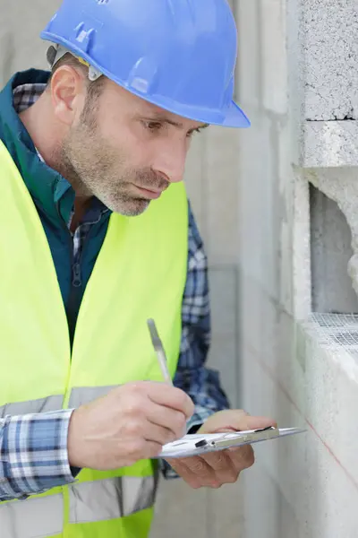 construction home inspector checking house