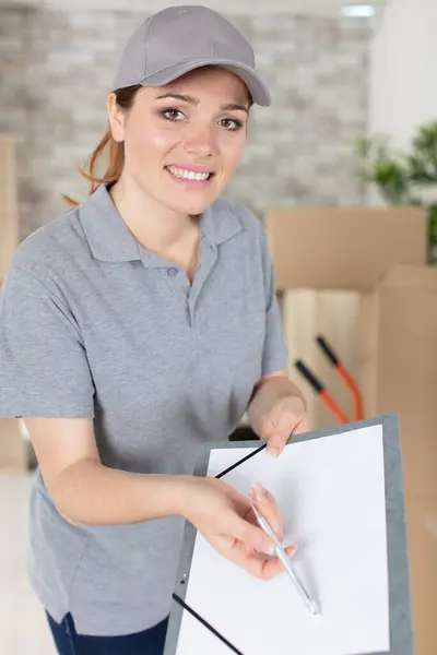 Portrait Young Delivery Woman Showing Confirmation Document Stok Resim