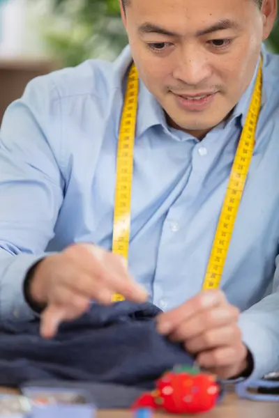 stock image focused man seamstress sewing in workshop