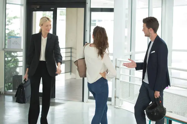 stock image group of happy young business people walking the corridor