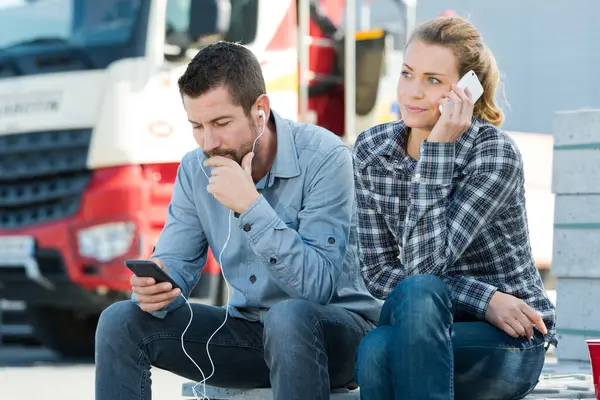 stock image workers listening to music outdoors