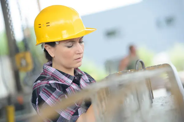 stock image female worker on building site looking at rebars